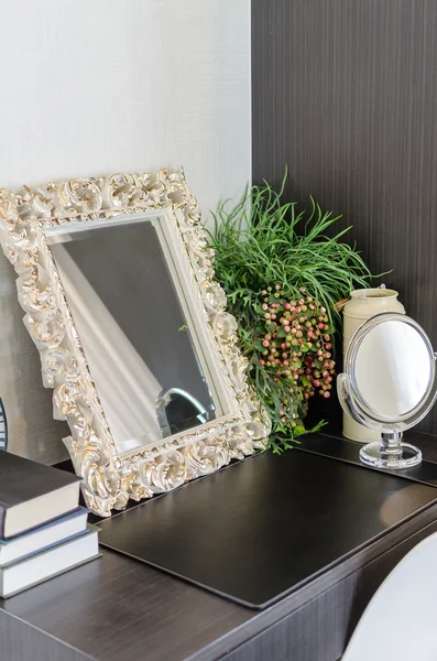 Mirror in classic frame style on dressing table