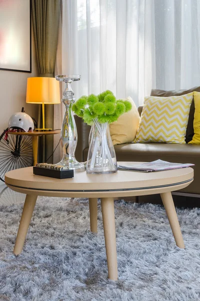 Wooden round table on carpet in living room