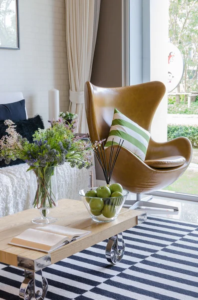 Modern living room with plant in vase on wooden table