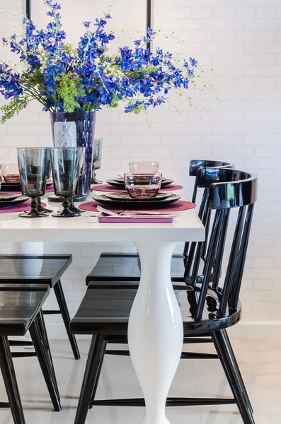 White dinning table with black chair in dinning room