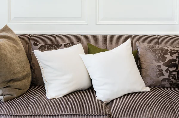 White pillows on brown sofa