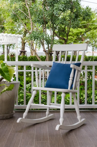 White wooden rocking chair on front porch