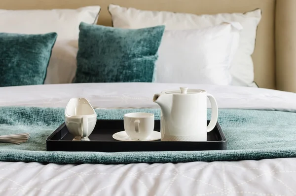 Tea set on black tray in bedroom