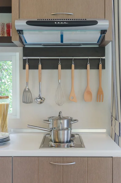 Stainless pan on gas stove with hood