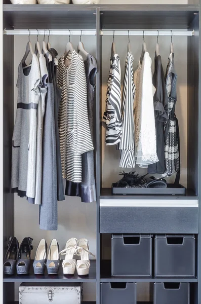 Black and white clothes in black closet