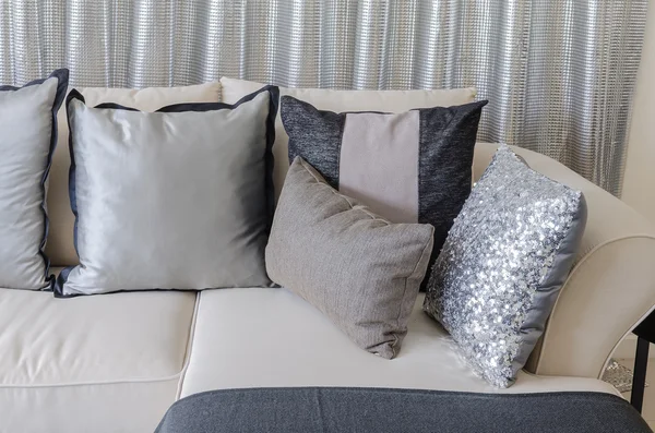 Pillows on sofa with steel curtain as background