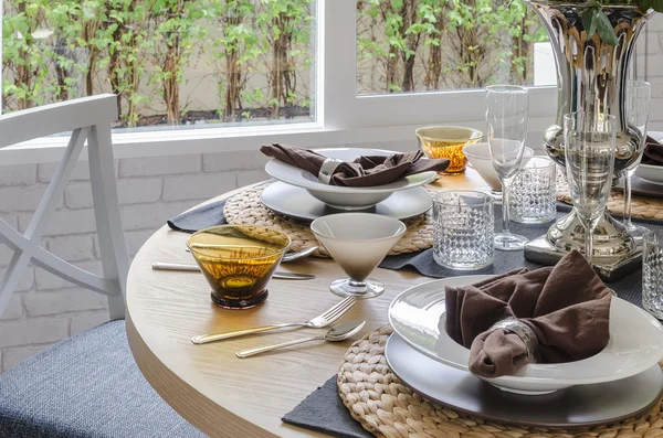 Table set on wooden round table in dining room