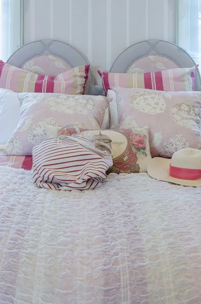 Colorful pillows on pink bed