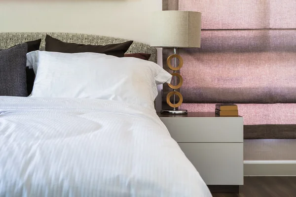 White pillows with white blanket on modern bedroom