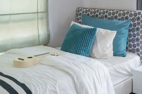 Green pillows on modern bed