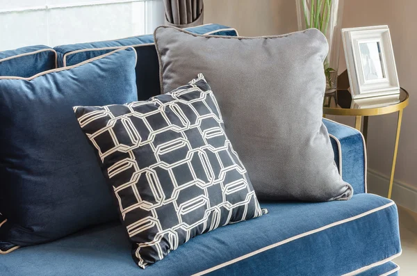 Black and white pillows on classic blue sofa in living room