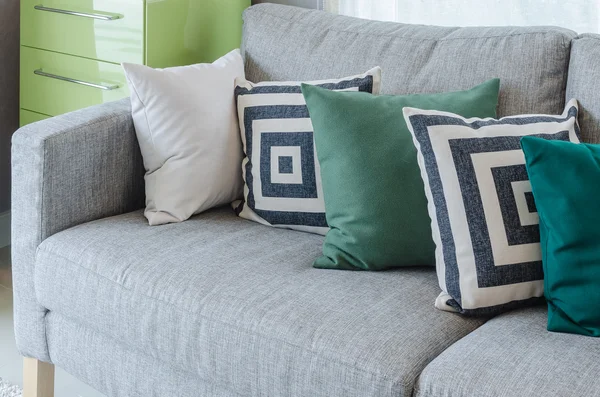 Modern grey sofa with black and white and green pillows
