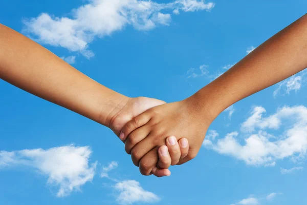 Couple holding hands sky background