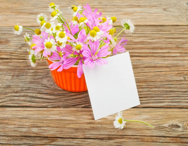 Flowers and a white blank sheet of paper
