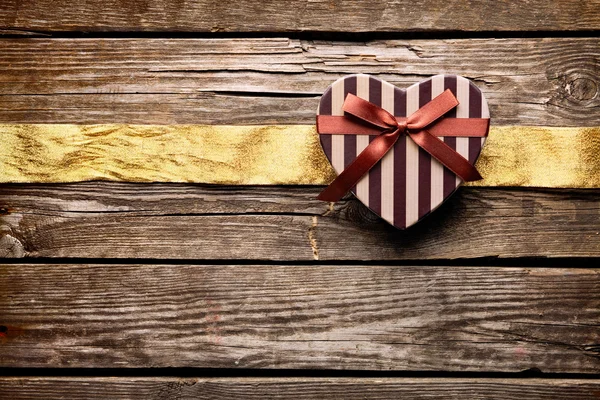 Gift box with wrinkled golden ribbon