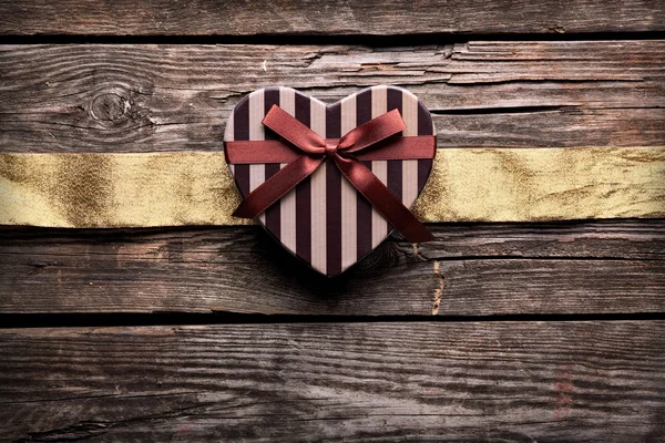 Gift box with wrinkled golden ribbon