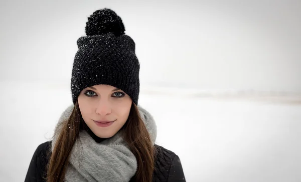 Outdoor portrait of a young girl in winter hat
