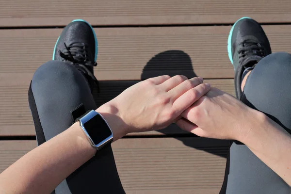 Fitness people using smart watch. Women runner getting ready for jogging. Sport, active lifestyle concept