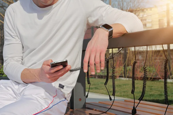 Man using solag charger for mobile phone close up