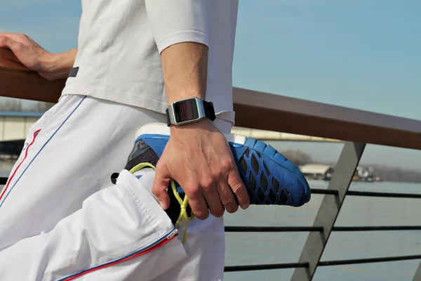 Man stretching after workout outdoors close up.  Running, sport, healthy active lifestyle concept.