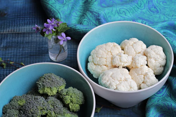 Broccoli and cauliflower, fresh vegetables on wooden background. Healthy eating, vegan concept