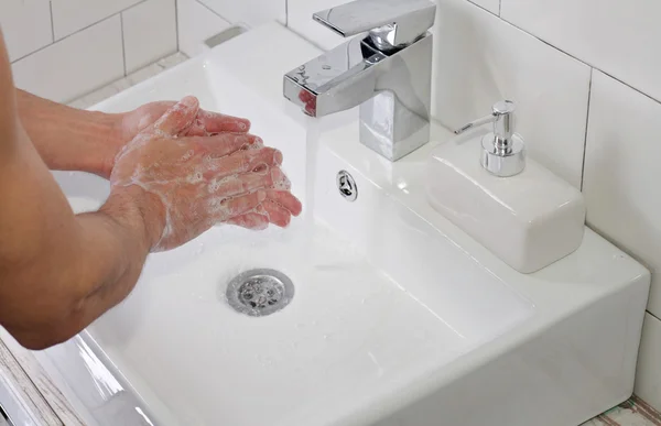 Hygiene concept. Man washing hands close up
