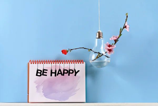 Be happy inspiration motivation quote and Modern bulb vase with flowers. Copy space image. Colorful minimalistic background. Happiness positivity concept