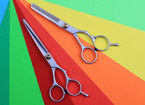 Stylish  Hair Cutting  Scissors on colorful, simple, minimalistic, geometric background. Hairdresser salon concept. Haircut accessories
