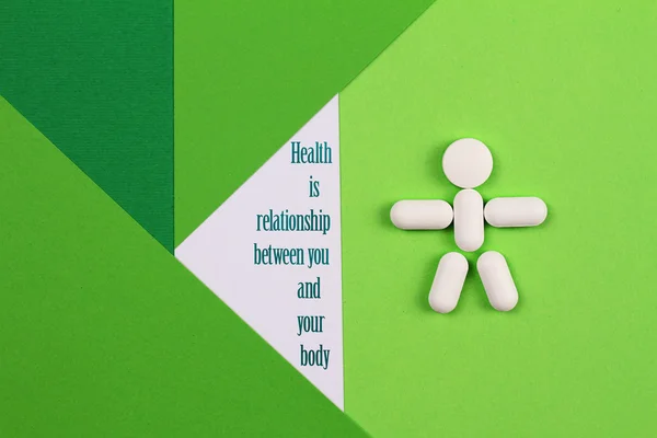 Health is a relationship between you and your body quote. Healthcare and medical concept. Pills on  colorful, simple, minimalistic, geometric background.  Cope space image