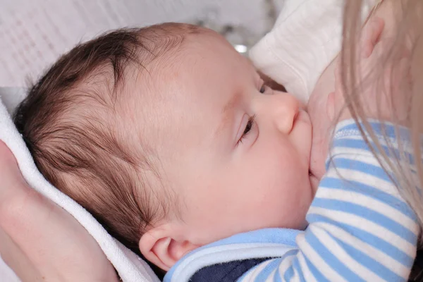 Breastfeeding. Mother breastfeeding infant baby boy