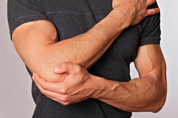 Man With Pain In Elbow. Pain relief concept