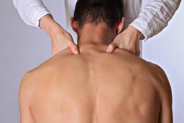 Chiropractic, osteopathy, dorsal manipulation, acupressure. Therapist doing healing treatment on man\'s back. Alternative medicine, pain relief concept