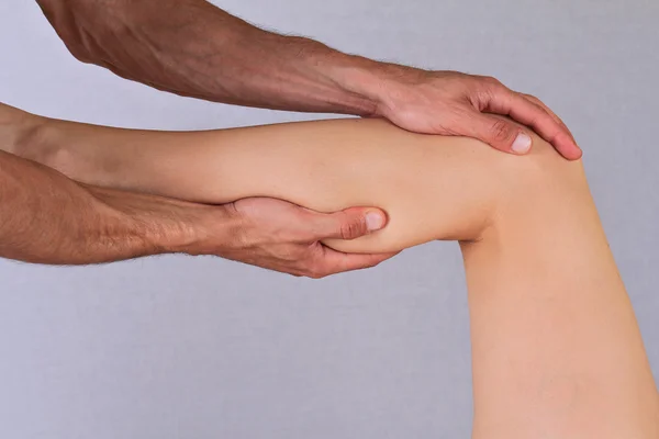 Chiropractic, osteopathy,  physical therapy. Therapist  doing healing treatment on woman\'s knee . Alternative medicine, pain relief concept