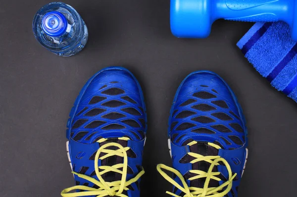 Sport Man, Fitness, working out concept background. Male Sport shoes, dumbbells and bottle of water