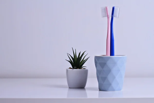 Misunderstanding, problems in relationships, different opinions concept. Male and female toothbrush standing back to back