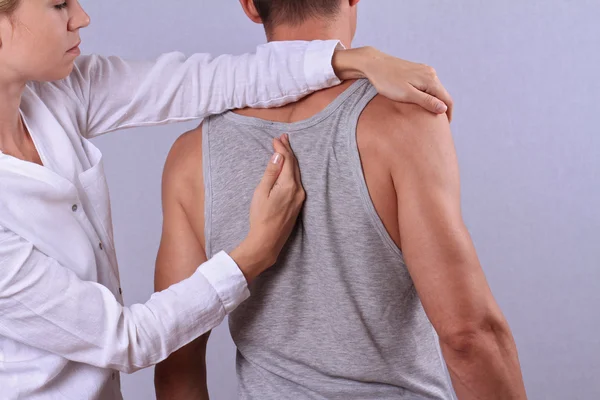 Chiropractic, osteopathy, manual therapy. Therapist doing healing treatment on man\'s back . Alternative medicine, pain relief concept