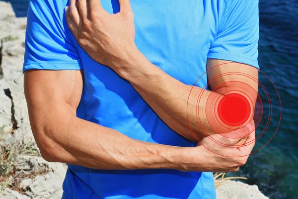 Man With Pain In Elbow. Sport injury