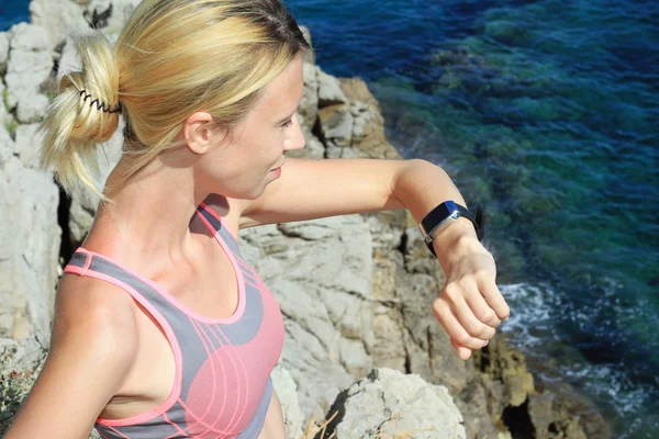 Woman runner checking time on smartwatch. Sport, fitness, active lifestyle