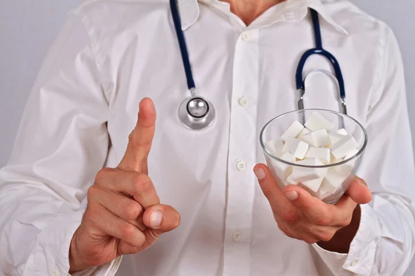 Doctor warning about white refined sugar effects. Health care and diabetes prevention concept