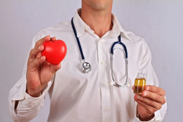 Doctor holding olive oil. Good Fats and Heart Health