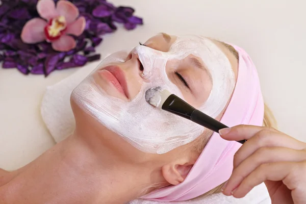 Young beautiful girl receiving facial mask in spa beauty salon.  Skin care, Beauty treatments.