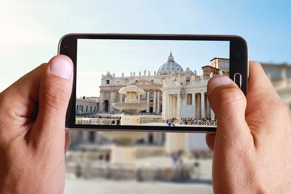 Male hand taking photo of st peter basilica in Vatican with cell, mobile phone. Europe travell, Italian holiday.