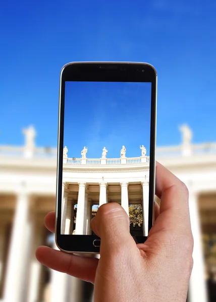 Male hand taking photo of columns in Vatican with cell, mobile phone. Europe travell, Italian holiday.