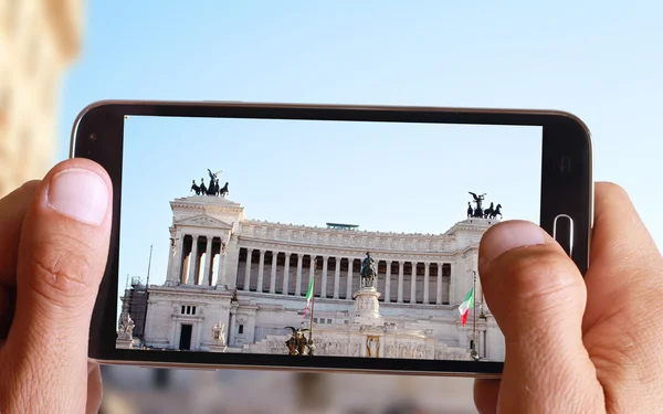 Male hand taking photo of Italian government building in Rome  with cell, mobile phone. Europe travell, Italian holiday.