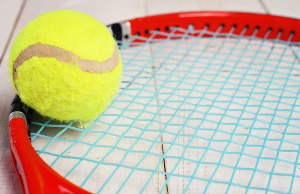 Close up on tennis racket and ball. Sport equipment background, wallpaper