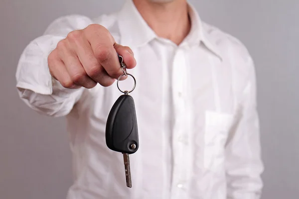 Close up of man hands holding  car key. Rent a car, car credit, buying new car concept