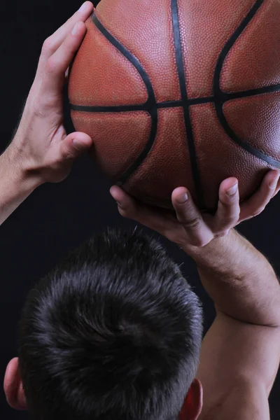 Man basketball player jumping dunking. Basketball player prepare to shoot ball.  Close up of man holding a basketball