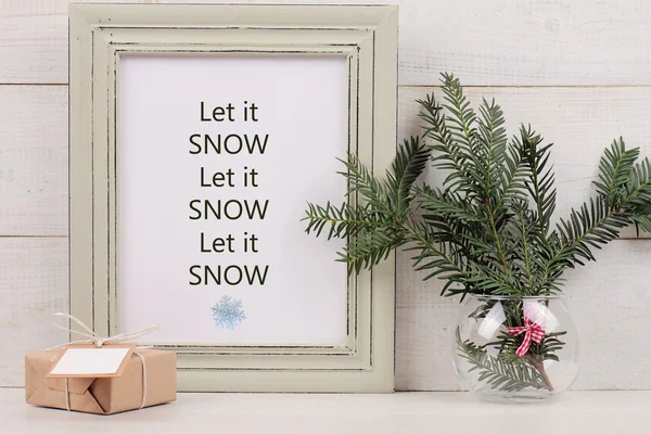 Merry Christmas and Happy New year concept.Let it snow poster in  shabby chick frame, vintage gift box with with copy space blank tag on white background. Scandinavian style interior decoration