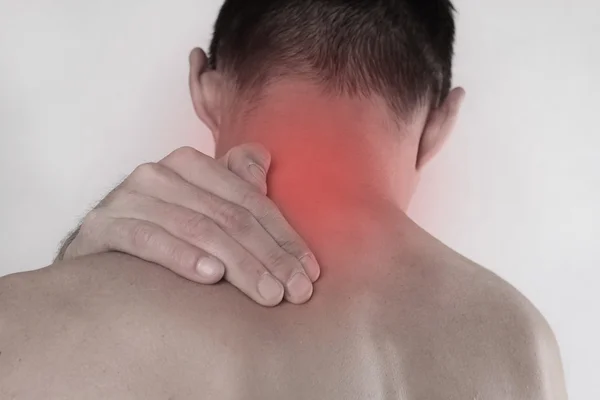 Close up of man rubbing his painful neck. Pain relief concept