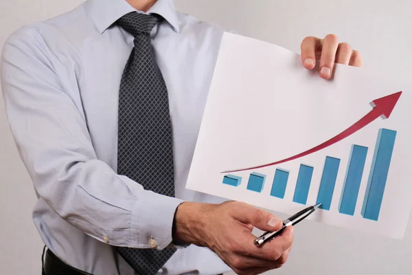 Close up of businessman showing  rising arrow, representing business growth. Manager showing presentation of progressive arrow chart. Success, team work, leadership concept